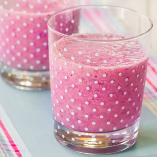 2 glasses filled almost to the top with thick pink milkshake.